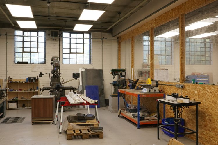 The wider makerspace with workshop machines and tall windows.