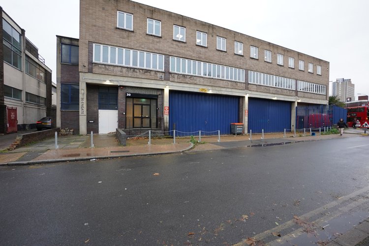 Blue Garage’s brick exterior with blue loading doors.